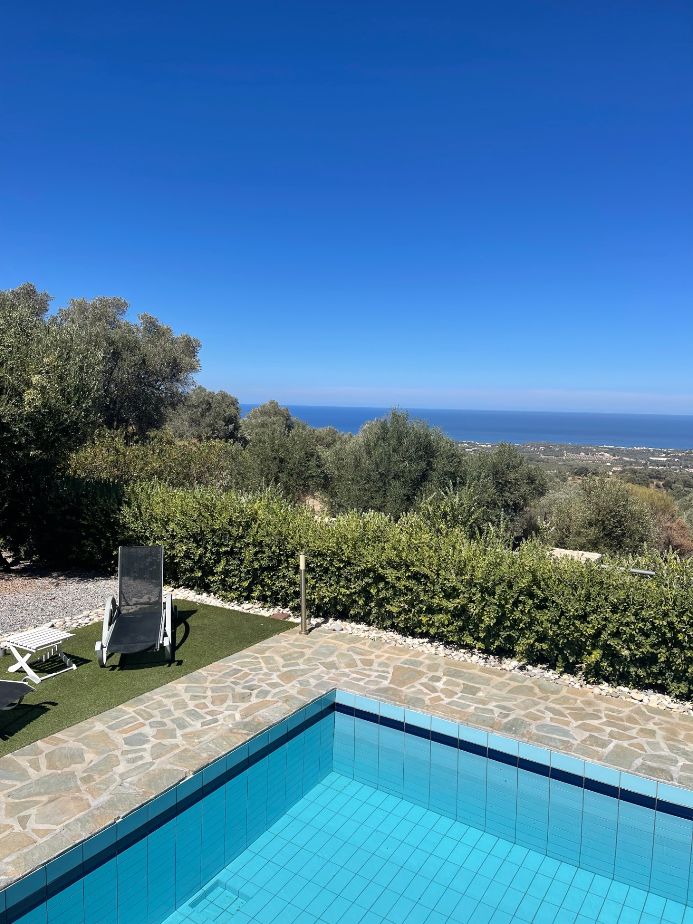 Sun lounger by the pool with sea horizon